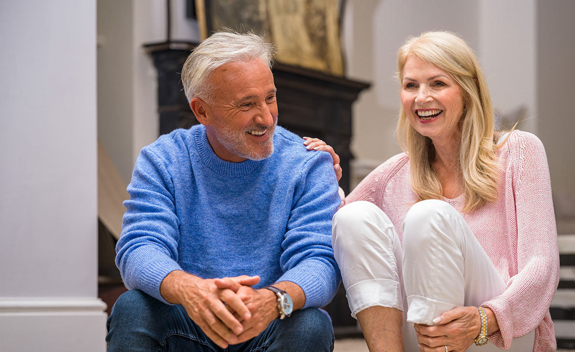 Couple sitting down on steps laughing