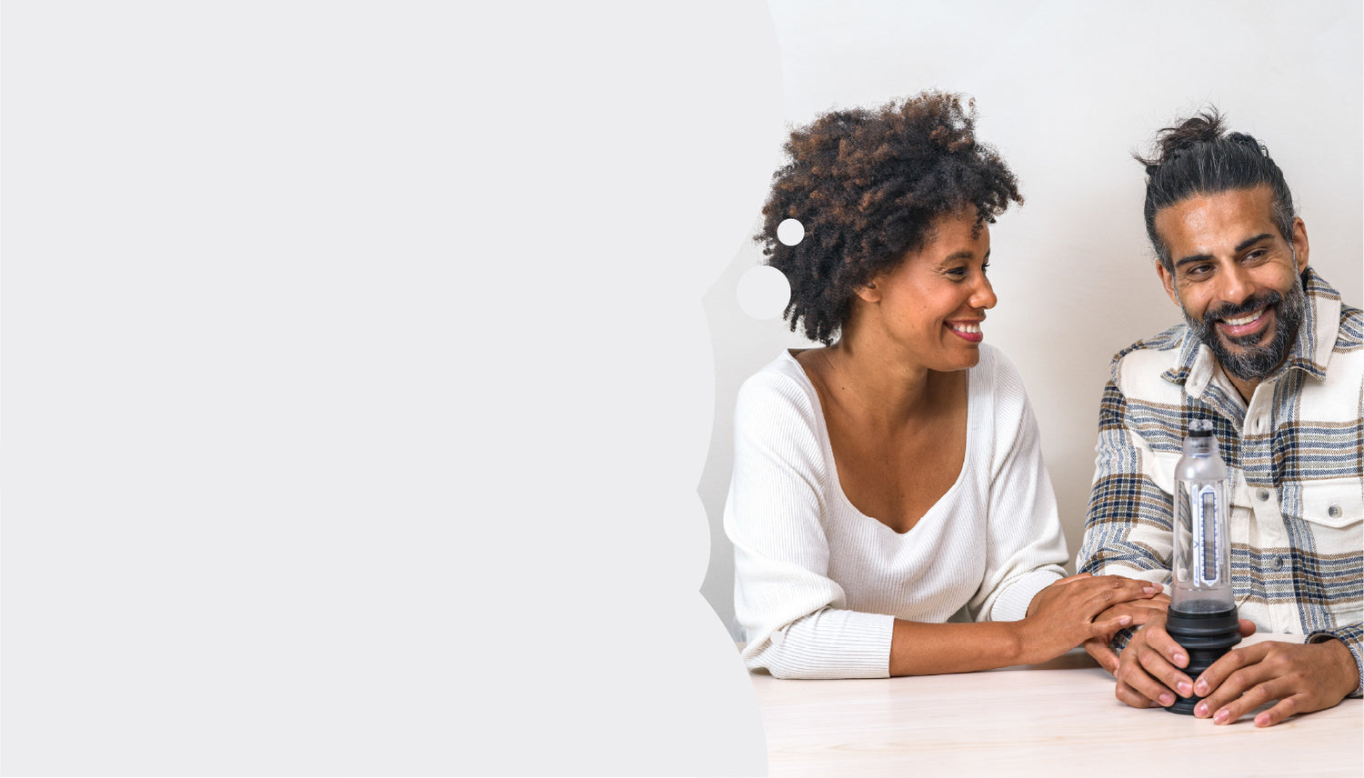 Man smiling while woman looks at him smiling