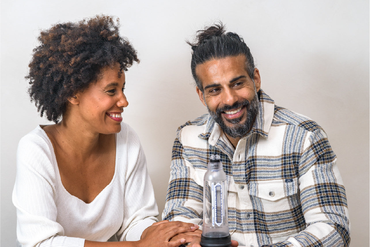 Man smiling while woman looks at him smiling