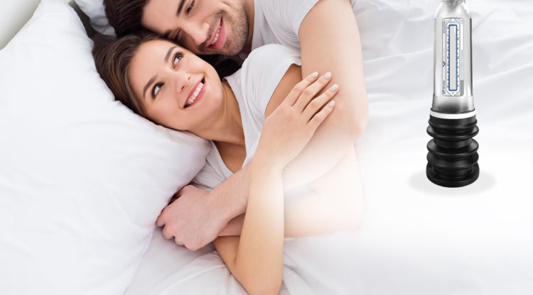 Man has his arms wrapped around a woman in bed with a VaxAid Pump next to them
